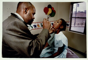 Francina Dye receives an oral exam from Dr. Michael Brooks at the West End Medical Center's Bowen Homes location, January 23, 1992