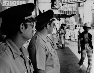 Two police officers survey activity on Broad Street, October 29, 1973