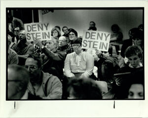 Ken Sandy and Brandon Larson Hold Signs Protesting Plans of Developer Richard M. Stein to Rezone 992 Acres in Suwanee, February 25, 1987