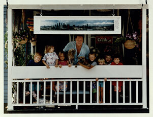 Photographer Ray Herbert on his porch with kids from the neighborhood, August 9, 1991