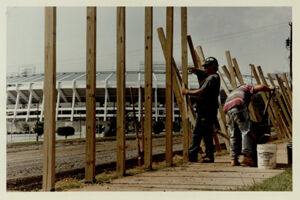 David Clark and Grady Welborn build a fence to go around Olympic Stadium construction site, July 30, 1993
