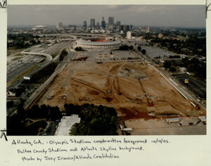 Construction of Olympic Stadium with Fulton County Stadium and Atlanta skyline in background, October 20, 1993