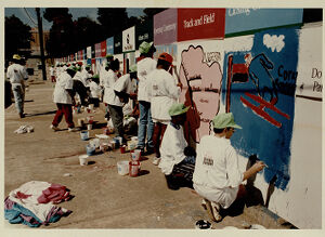 Students from Martin Luther King Middle School paint panels on the construction barricade around the Olympic Stadium, October 14, 1993