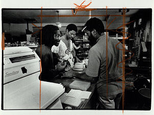 Saleem Shaheed, Llaila Afrika, and Wanzu, manager of Freedom Foods Health Corp., inside his store, undated