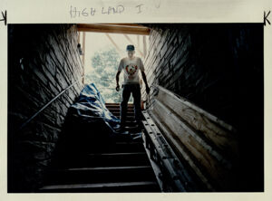 John Smith in the entrance of a hotel's basement where he is working on renovations, June 2, 1994