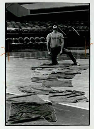 Scott Ward checks roof leakage inside the Omni International, December 1, 1982