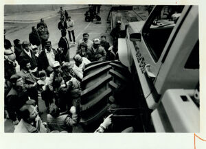 A crowd gathers around a car at the Omni Championship Hot Rod Pull, January 28, 1985