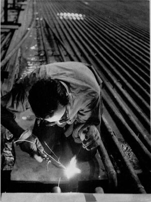 Larry Caldwell working on the refrigeration unit of the Atlanta Coliseum's ice rink, August 31, 1972