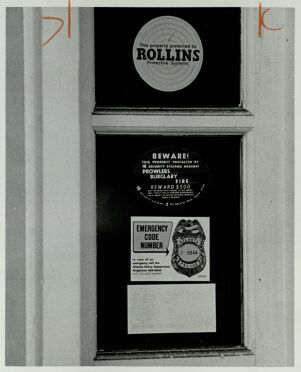 Security system signs outside of an office building, April 17, 1979