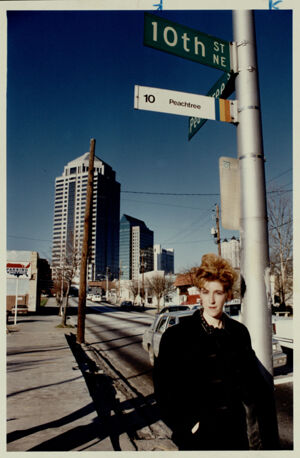 Josie Long, Midtown resident, at the corner of 10th and Peachtree Streets awaiting a bus, January 17, 1991