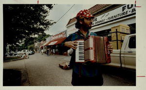 Maurice Wolfgang plays the accordion in Little Five Points, June 22, 1991