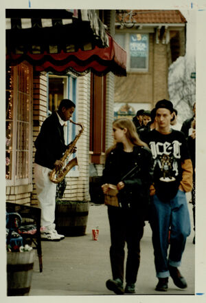 Zachery Grady plays the saxophone in Little Five Points, January 14, 1993