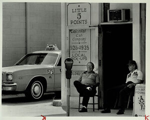 Jack Mitchell and Evert Smith outside the Colonial Cab Co. in Little Five Points, undated