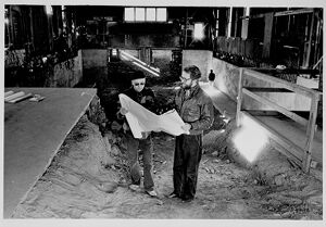 Bob Eberwein and Robert Denson look over blueprints for the Edgewood Railcar Barn, undated