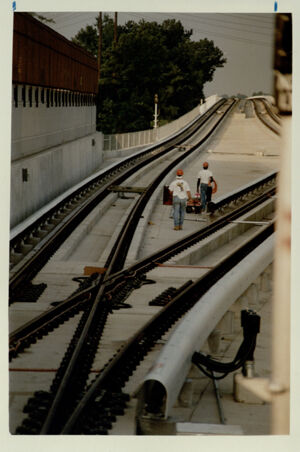 Two construction workers walking along the tracks of MARTA, August 13, 1992