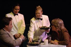 Clay Martin and Dena Malon (seated), being served by Denise Arribas and Mary Claire Dunn, in the 7 Stages Theatre's production of "Nickel and Dimed," Atlanta, Georgia, April 27 - May 28, 2006.