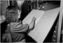 Georgia State University music archivist Chris Paton with WSB log book, 1985