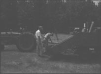 John Hensley - Asst. County Agent and George Eager getting combine ready for harvest.