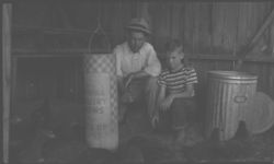B. B. Campbell, C. A., and Tom Collins, 4-H boy with his poultry feeder
