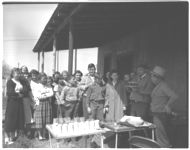County agent J. J. Reid of Schley County at the Soil Testing mobile unit in Schley County; A group of school children and their teachers look on as testing continues