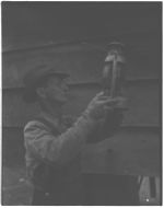 E. P. Ledford cleaning lantern. Bull Creek community just getting electricity