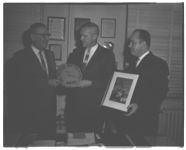 Director Sutton receiving film from W.E. Butler, Jr