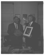 Director Sutton receiving film from W.E. Butler, Jr