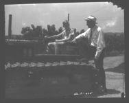 Bert Robinson, Jr. gets the feel of the new tractor recently purchased by president of the corporation farm. Talking with Bert is president and stockholder John Brown