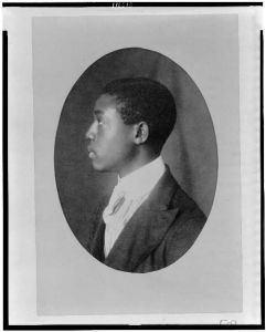 [African American man, head-and-shoulders portrait, left profile]