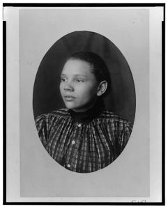 [African American girl, head-and-shoulders portrait, facing left]