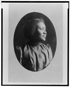 [African American woman, head-and-shoulders portrait, facing right]