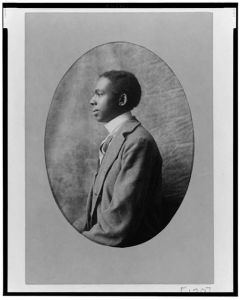 [African American man, half-length portrait, left profile]