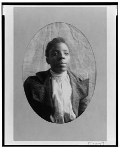 [African American woman, head-and-shoulders portrait, facing slightly right]