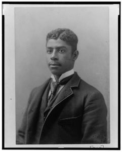 [African American man, head-and-shoulders length portrait, facing left]