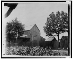 [Barn and other buildings behind fence in Georgia]