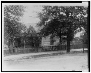 [House with picket fence and trees]