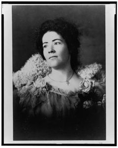 [Nursing student wearing a fur collar and lace dress, head-and-shoulders portrait, facing left]