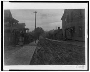 [Unpaved street with houses in Georgia]