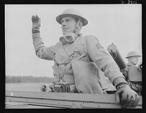 Fort Benning. Armored forces peronnel. Sergeant of the armored forces and commanding officer of a halftrac scout car. One of the capable men teaching recruits at Fort Benning, Georgia some of the good American ways of upsetting Japanese schedules