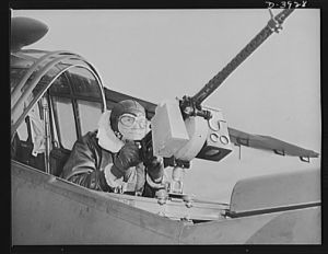 Fort Benning. Aerial machine gunners. Four aces. This crack aerial machine gunner is part of an unbeatable combination. He has a fast, accurate gun and the world's best in the way of plane and pilot
