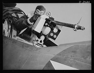Fort Benning. Aerial machine gunners. Four aces. This crack aerial machine gunner is part of the unbeatable combination. He has a fast, accurate gun and the world's best in the way of plane and pilot