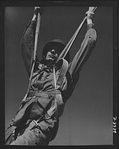 Fort Benning. Parachute troops. Ready to make port. A student paratrooper at Fort Benning, Georgia who bailed out of a plane a few minutes ago is about ready to take the ground and perform the little chore of getting his chute under control