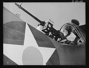 Fort Benning. Aerial machine gunners. Four aces. This crack aerial machine gunner is a part of an unbeatable combination. He has a fast, accurate gun and the world's best in the way of plane and pilot