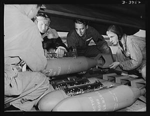 Fort Benning. Loading planes. Axis, beware! Bombardiers in training at Fort Benning, Georgia use practice bombs to learn the routine of loading a light bombing plane