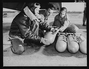 Axis, beware! Bombardiers in training at Fort Benning, Gerogia use practice bombs to learn the routine of loading a light bombing plane