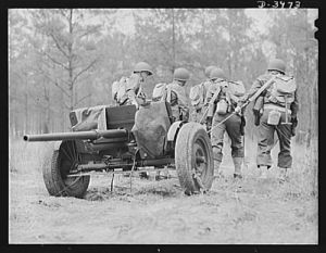 Fort Benning. Anti-tank gun crews. Manhandling a 37mm anti-tank gun into position is only one of the chores that young gun crews training at Fort Benning, Georgia take in stride