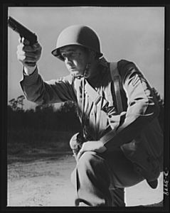 Fort Benning. Anti-tank gun crews. He's good with any kind of gun. This infantryman, finishing training at Fort Benning, Georgia, belongs to the crew of a 37mm anti-tank gun