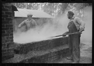 [Untitled photo, possibly related to: Cleaning turpentine cups in boiling water at a still near Pembroke, Georgia]