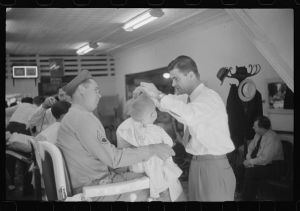 Sergeant from Fort Benning getting his son's hair cut at a barber shop in Columbus, Georgia