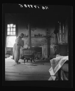 Interior of a plantation house now vacant but for two rooms occupied by an old Negro couple, tenants. Greene County, Georgia
